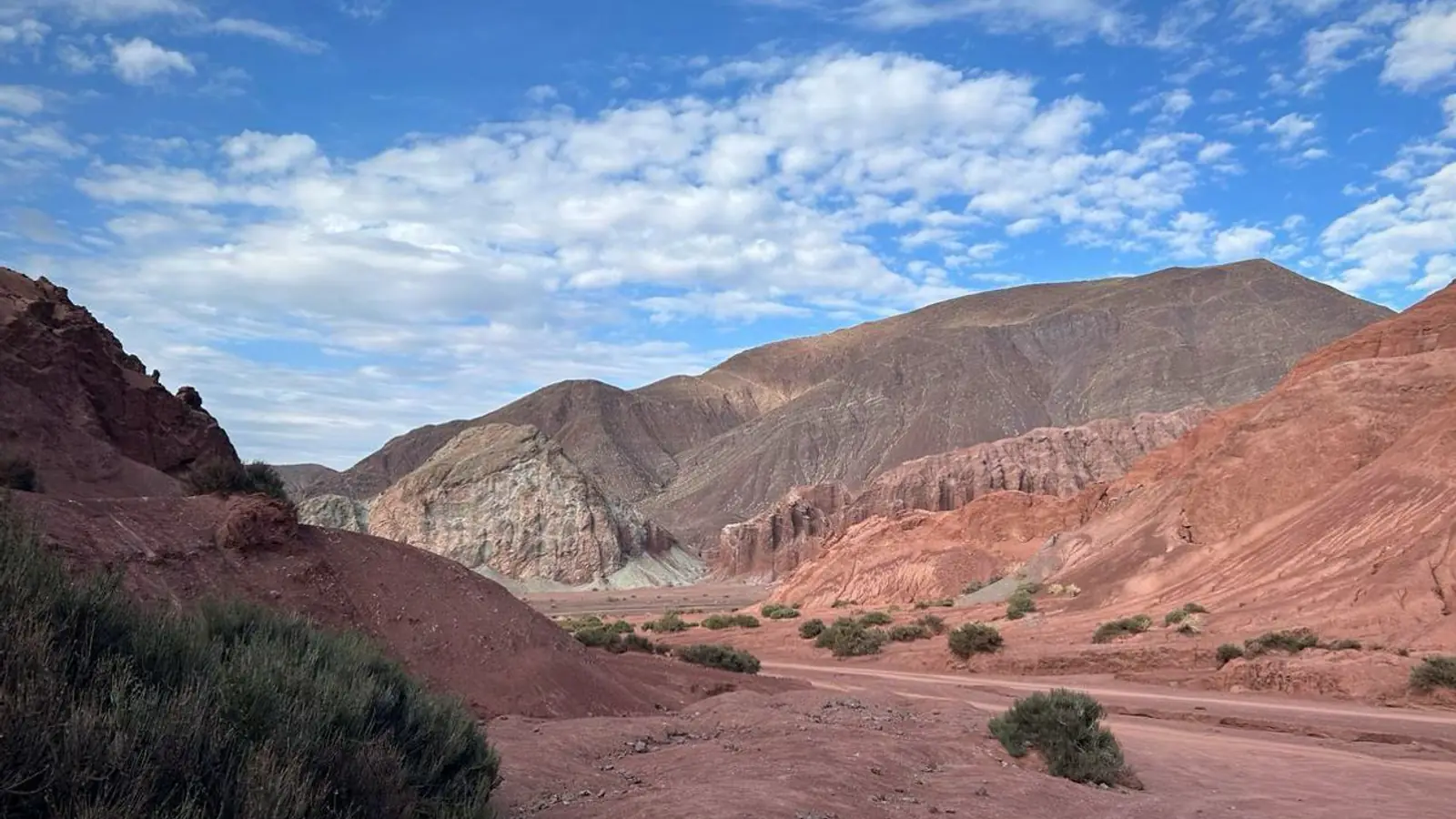 Mineral-banded desert hills in strong daylight
